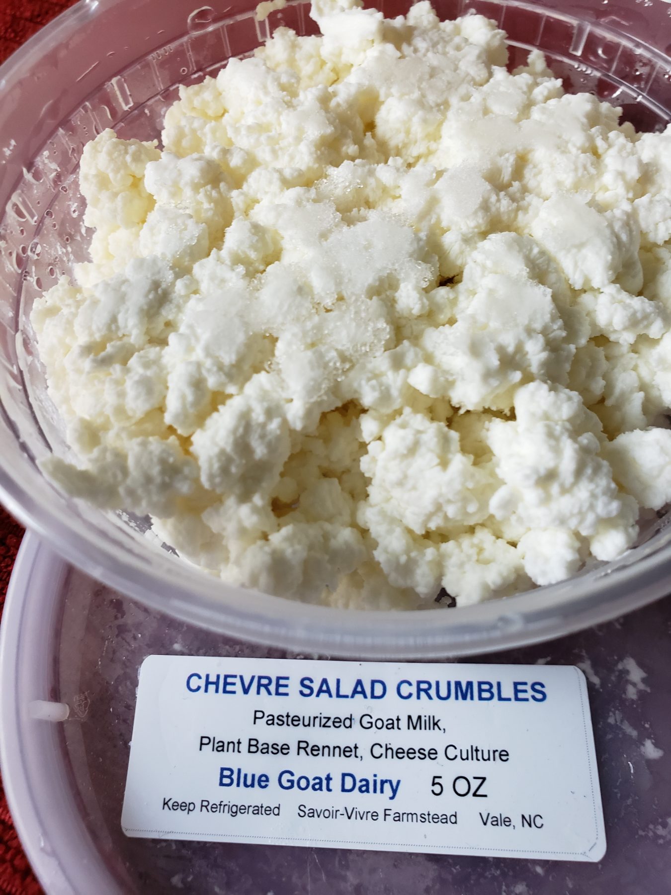 A five-ounce tub of Blue Goat Dairy chevre salad crumbles with its ingredient label