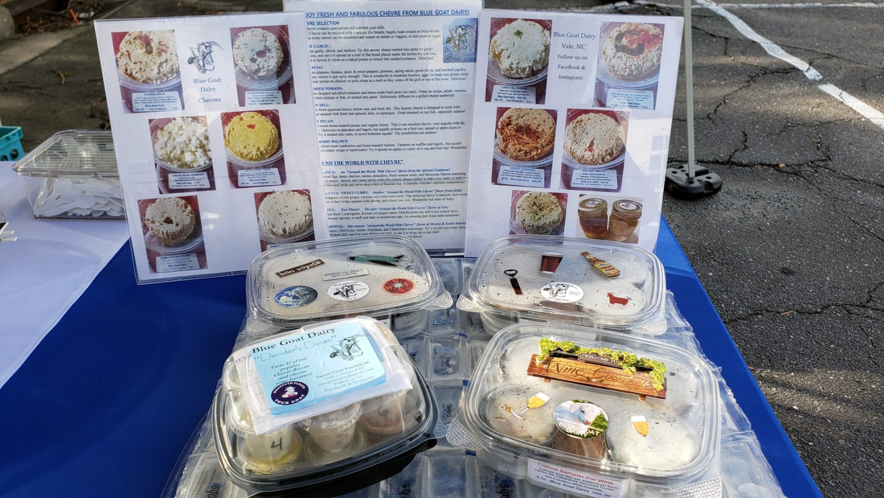 The Blue Goat Dairy market table: combo packs, sample containers and the laminated chevre selection sheets